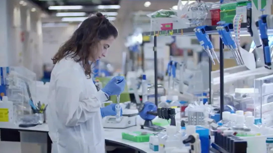 A scientist pipetting at the Elixrbio lab bench